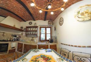 a kitchen with a table and a ceiling at Agriturismo Circugnano in Grassina