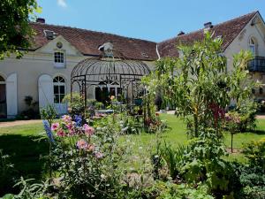 a garden in front of a house with a gazebo at La Mare Aux Bambous in Couffy