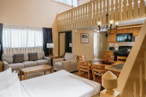 a living room with a kitchen and a dining room at Mammoth Mountain Inn in Mammoth Lakes