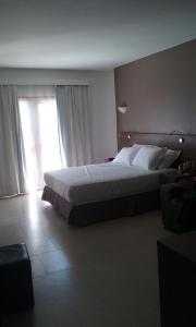 a bedroom with a large bed and a window at Wind e Blue in Jericoacoara +63 photos