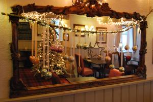 a mirror with christmas ornaments in a room at The Miners Arms in Eyam