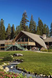 a large building with a river in front of it at Mammoth Mountain Inn in Mammoth Lakes