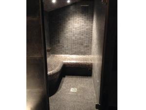 a bathroom stall with a bench in a restroom at La Casa Nert in Millas