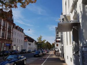 a city street with cars parked on the side of a building at Nauwieser Apartments in Saarbrücken +7 photos