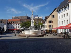 a large fountain in the middle of a city street at Nauwieser Apartments in Saarbrücken