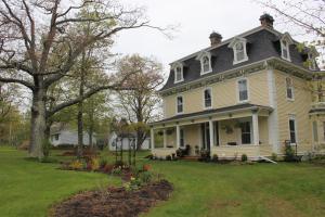 a large white house with a large yard at Maplehurst Manor Bed and Breakfast in Dorchester