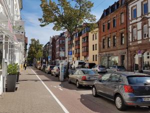 una calle de la ciudad con coches aparcados en la calle en Nauwieser Apartments en Saarbrücken