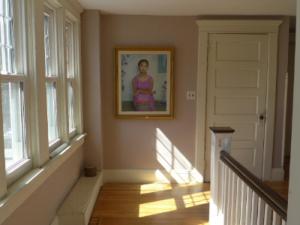 a hallway with a painting on the wall and a door at Morning Glory B&B in Woodstock