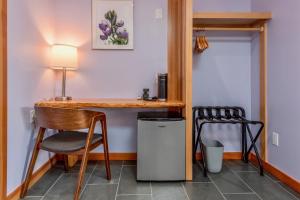 a room with a desk and a chair and a trash can at Wildflower Boutique Motel in Point Arena