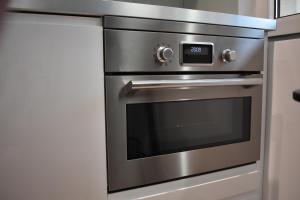 a stainless steel oven in a kitchen at Apartament Nadmorski in Ustka