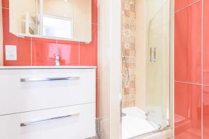 a bathroom with a shower and a sink and a toilet at MM Suites Reims Centre Terasse in Reims +16 photos