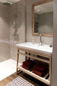 a bathroom with a sink and a shower at l'Herbier - chambre d'Hôtes - in Marnaz