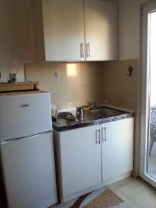 a kitchen with a sink and a white refrigerator at Top Jaz Apartments in Budva