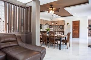 a kitchen and dining room with a couch and a table at Poonsiri Private Pool Villa Aonang in Ao Nang Beach