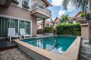 a swimming pool in front of a house at Poonsiri Private Pool Villa Aonang in Ao Nang Beach