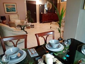 a living room with a table with dishes on it at maisonette with garden in Perea