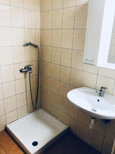 a bathroom with a shower and a sink at Kirkos Apartments in Kamariotissa