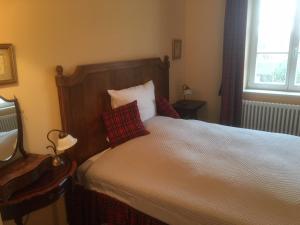 a bedroom with a bed with two pillows on it at B&B Fiddler's Inn in Neuruppin