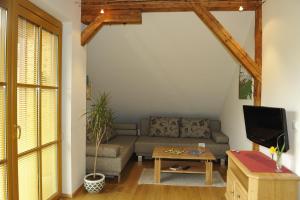 a living room with a couch and a table at Gut Neusess in Mauterndorf