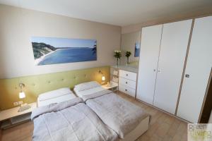 a bedroom with a bed and a view of a beach at Villa Franz in Heringsdorf