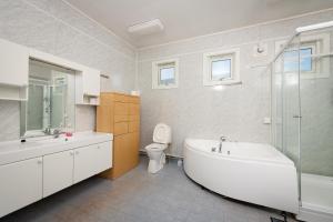 a bathroom with a tub and a toilet and a sink at Apt 103 - Andenes Whale Safari Apartments in Andenes