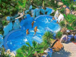 an overhead view of people in a pool at a water park at Portofelice Camping Village in Eraclea Mare
