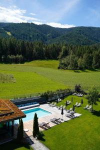 an aerial view of a resort with a swimming pool at Hotel Petrus in Brunico