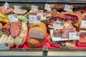 a display of different types of meats and bread at Portofelice Camping Village in Eraclea Mare