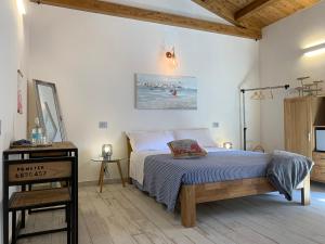a bedroom with a bed and a nightstand and a bed sidx sidx sidx sidx at Rosamare in Cesenatico