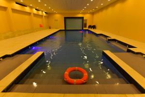 a swimming pool with an orange buoy in the water at Sahary Al Ula Resort in Al-ʿUla