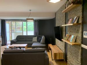 a living room with a couch and a table at Apartamenty Stara Polana in Zakopane