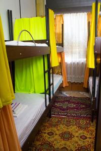 a room with two bunk beds with yellow curtains at КЛУБ B55 in Dnipro