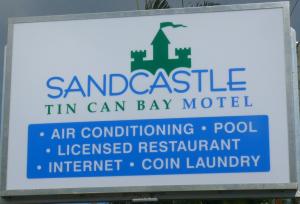 un panneau indiquant le santragello in can bay motel dans l'établissement Sandcastle Motel Tin Can Bay, à Tin Can Bay