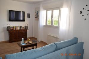 a living room with a blue couch and a table at Bellsol in Cala Ratjada