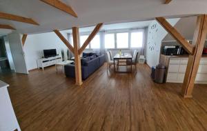 a living room with a blue couch and a table at Ferienwohnung Emely in Mechernich