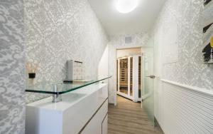 a white kitchen with a glass counter top at FeWo an der Havel in Zehdenick +27 photos