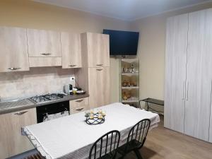 a kitchen with a table with a bowl of fruit on it at Agave in Reggio Calabria