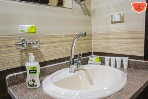 a bathroom sink with a bottle of soap on it at Maamoura Armed Forces Apartments in Alexandria