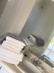 a pile of towels sitting on top of a bathroom sink at Peacock Studios in Pefki