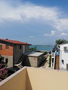 a view from the balcony of a building with the ocean at Apartment Vitko in Nin