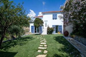 a yard with a stone path in front of a house at Il Sole di Poggi in Imperia +73 photos