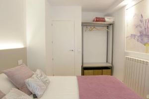 Postel nebo postele na pokoji v ubytování VUT La Casa de las Flores