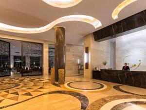 a lobby of a hotel with a circular floor at Mövenpick Hotel du Lac Tunis in Tunis