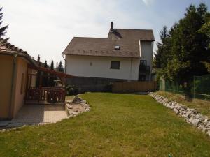 a white house with a fence and a yard at Privát Szállás Miskolctapolca in Miskolctapolca
