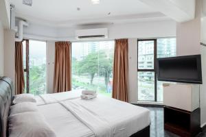 a bedroom with a white bed and a large window at Subang Park Hotel in Subang Jaya