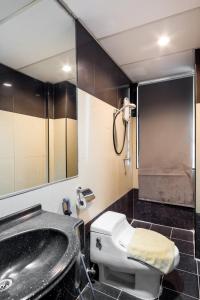 a bathroom with a sink and a toilet and a tub at Subang Park Hotel in Subang Jaya