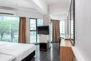 a hotel room with a bed and a flat screen tv at Subang Park Hotel in Subang Jaya