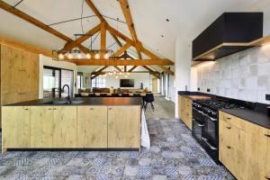 an open kitchen with wooden cabinets and a sink at DURBUY SUITES in Durbuy