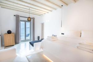 Postel nebo postele na pokoji v ubytování Obsession Mykonos