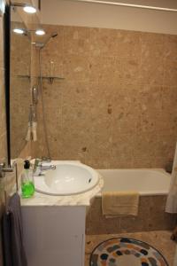 a bathroom with a sink and a bath tub at Vista Mar in Caniço +23 photos